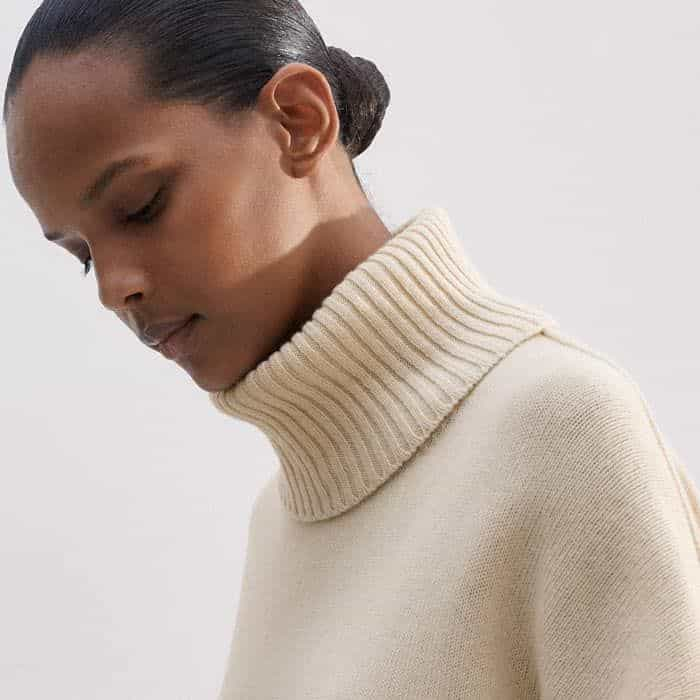 Create a high-neck silhouette by attaching the snood that secures with a series of concealed buttons on the round neckline.