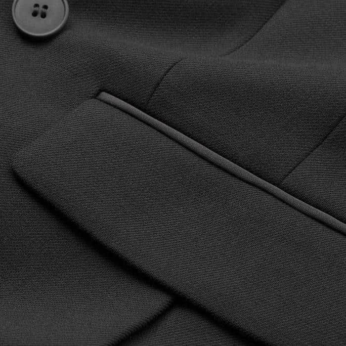 Wool-blend coating fabric, with satin tux detail on the lapel and satin-covered buttons.