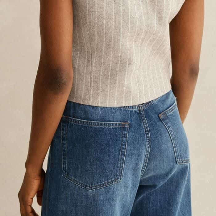 The cropped cut is specifically engineered to seamlessly line up alongside high waistlines.