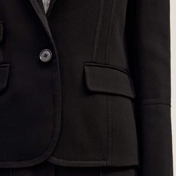  Two pockets feature on one side of the buttoned front and one on the other.