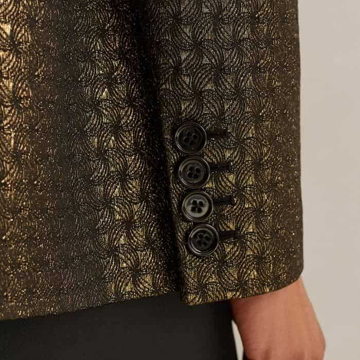 A series of black buttons are subtly present at the deep cuffs.