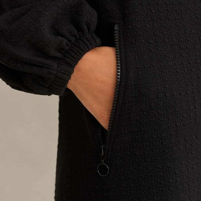 Keeping small essentials safe, the flattering pockets are fitted with zips.