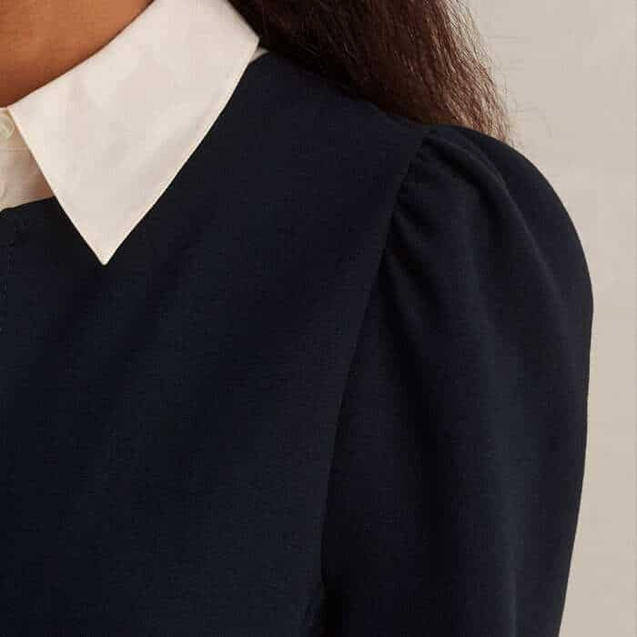 Making the shoulder appear narrower, the tops of the long sleeves feature a subtle pouf.