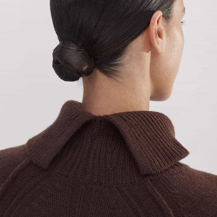 The high roll neck features a back split for adjustable styling. 