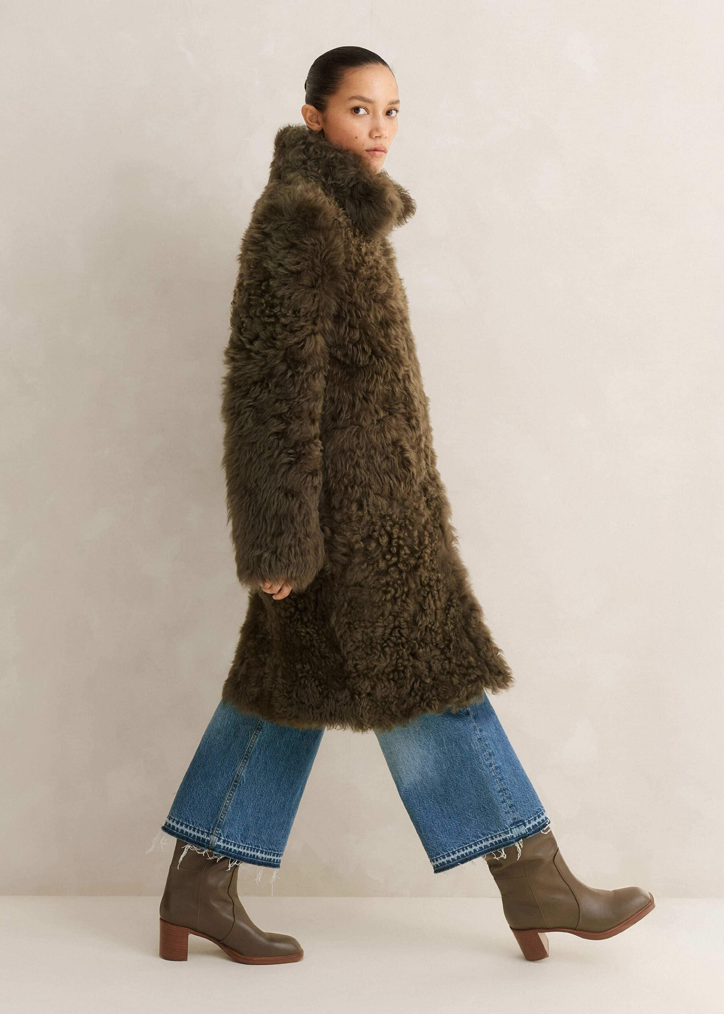 Crafted in the UK from shearling leather. This statement shearling features a natural curl on one side and suede-touch Nappa on the other.