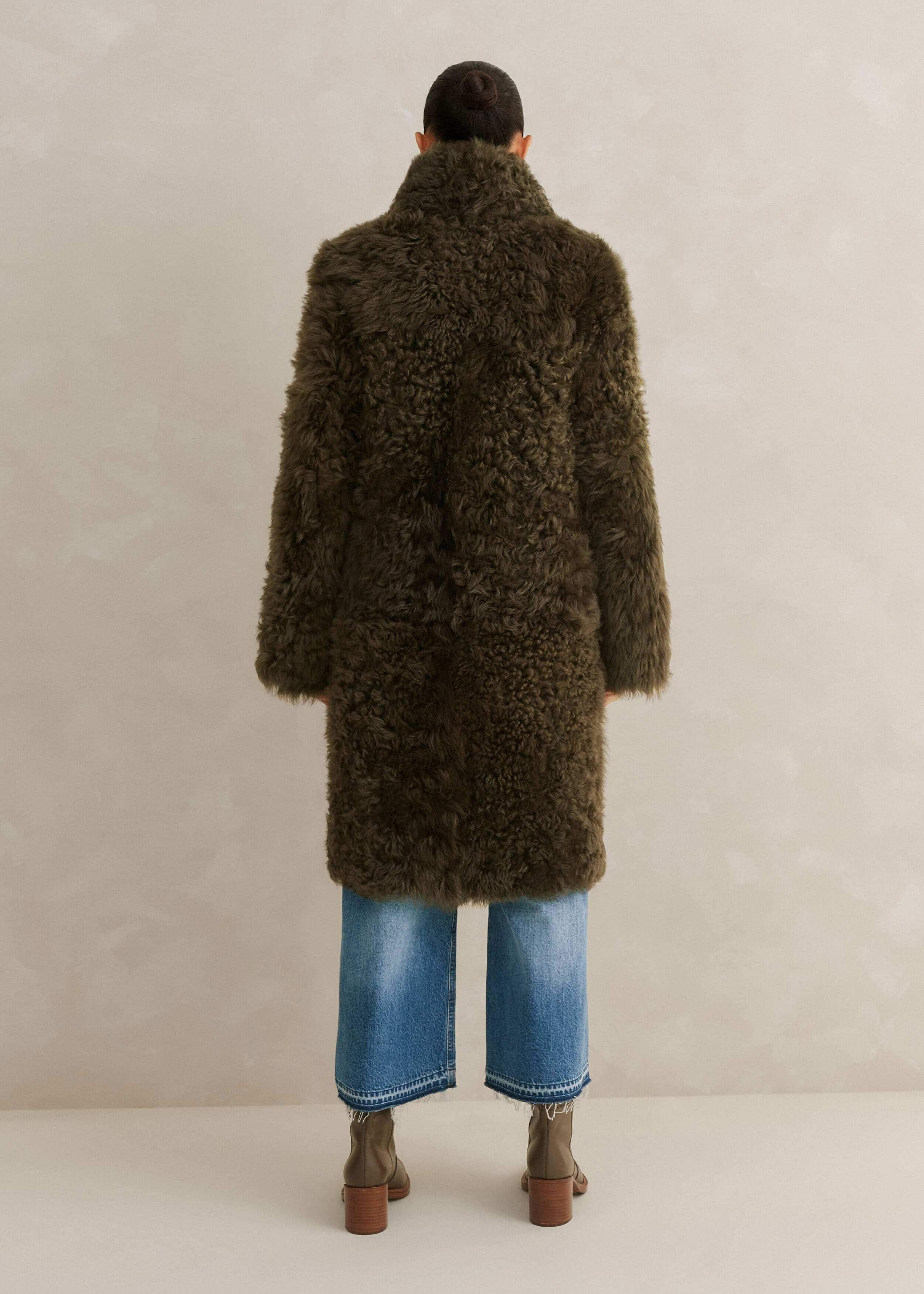 Crafted in the UK from shearling leather. This statement shearling features a natural curl on one side and suede-touch Nappa on the other.