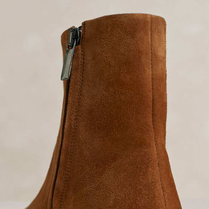 The heel appears as a block from the back but a more sculptural one when viewed from the side.