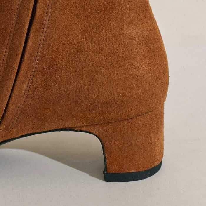 The heel appears as a block from the back but a more sculptural one when viewed from the side.