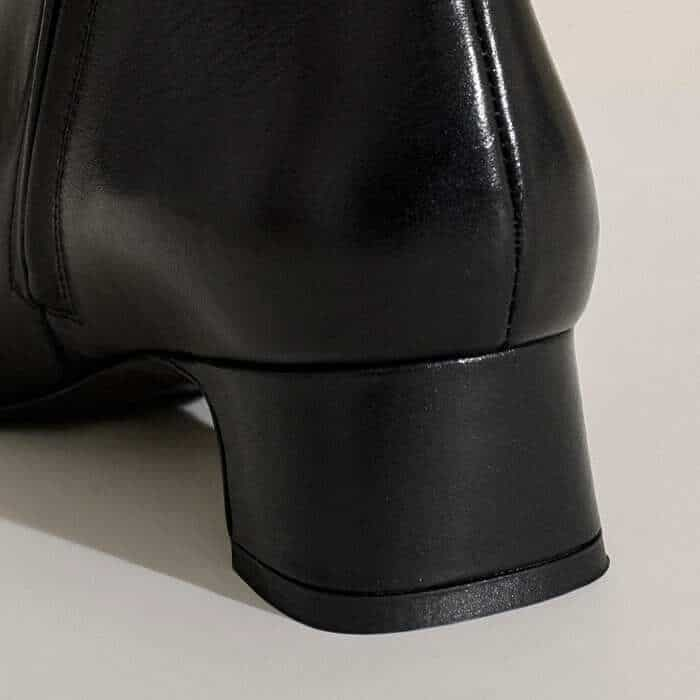 The heel appears as a block from the back but a more refined, elegant shape when viewed from the side.