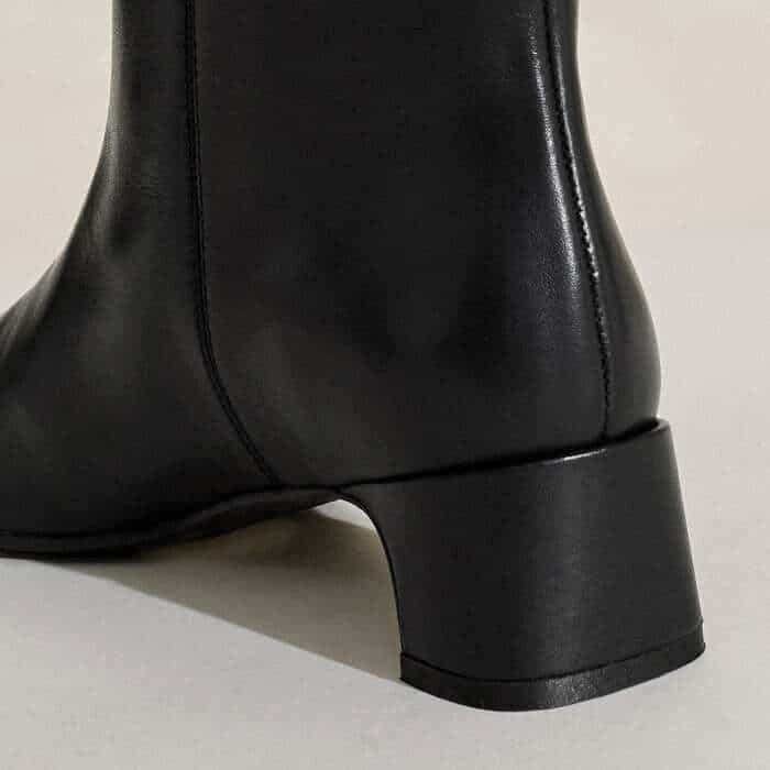 The set-back heel appears blocky from the back and more curved when viewed from the side.