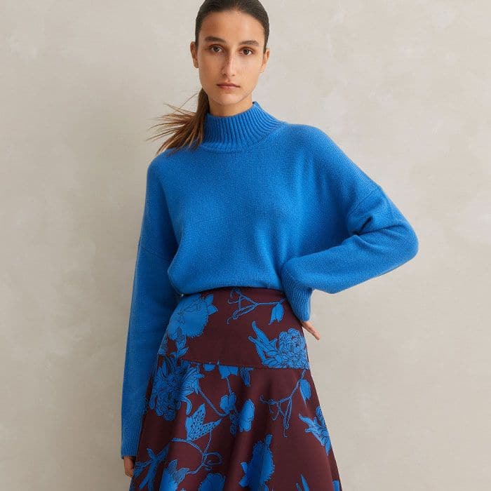 In the same bright blue hue as the print, our Merino Cashmere High Neck Curved Jumper completes a cohesive look. 