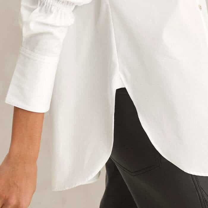 To ensure an even drape, the hem features side splits.