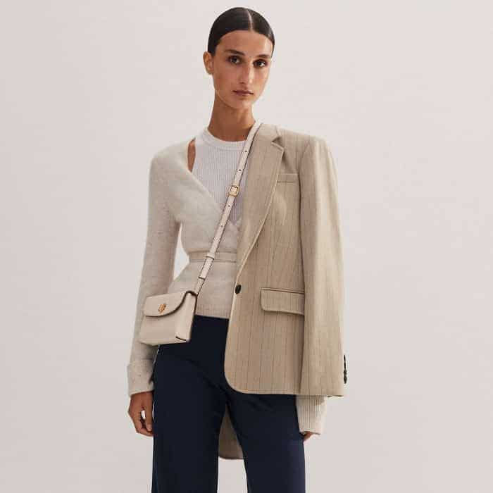 Achieve a high-low balance with our Cashmere Layered Knitted Wrap Top and Pinstripe Blazer.