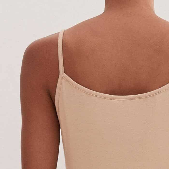 A high back ensures coverage when layering under dresses.