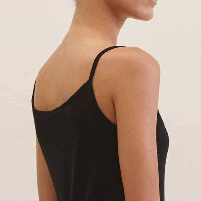 Keeping coverage in mind when layered under dresses, the back is shaped to a high silhouette.