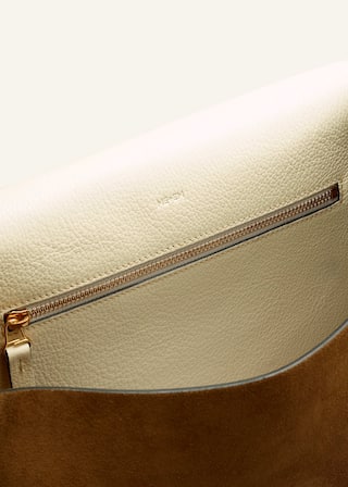 The sides of the bag are ruched to create a modern, sculptural finish whilst also accommodating more belongings.