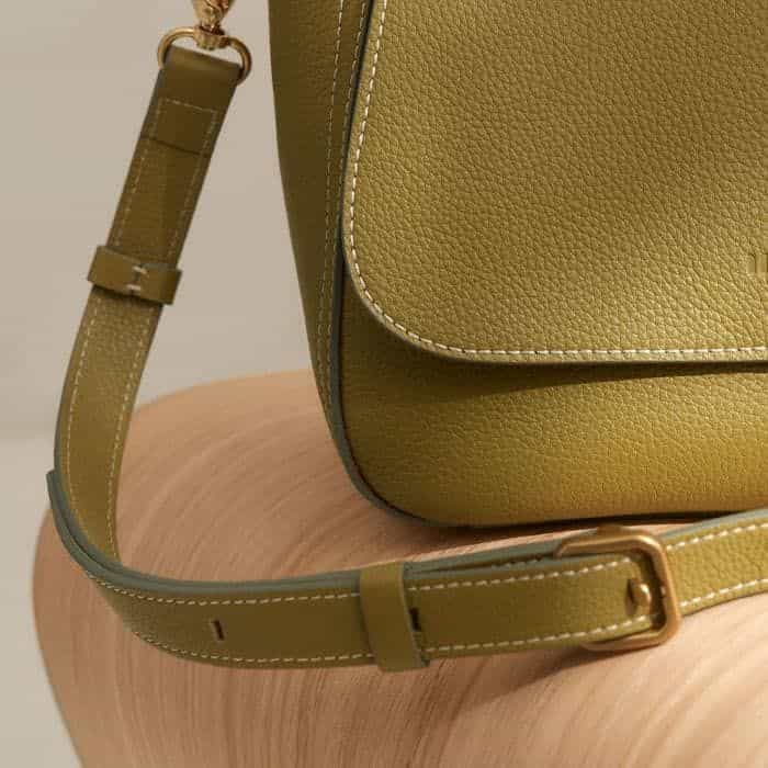 The strap has six holes so it can be adjusted to switch between a crossbody or shoulder bag. 