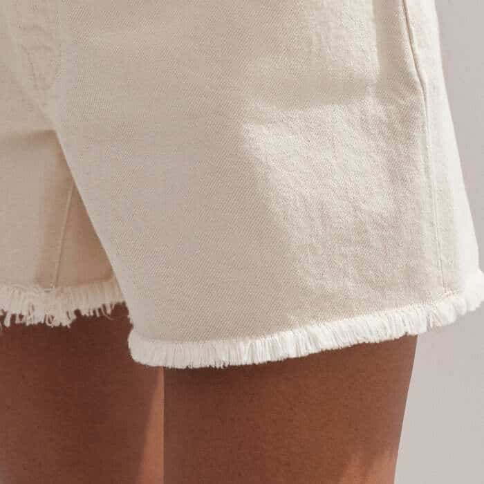 The frayed edge at the hem adds an authentic edge to the piece.