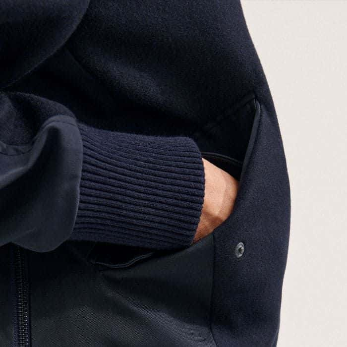 The functional pockets are topped with push-stud fastenings.