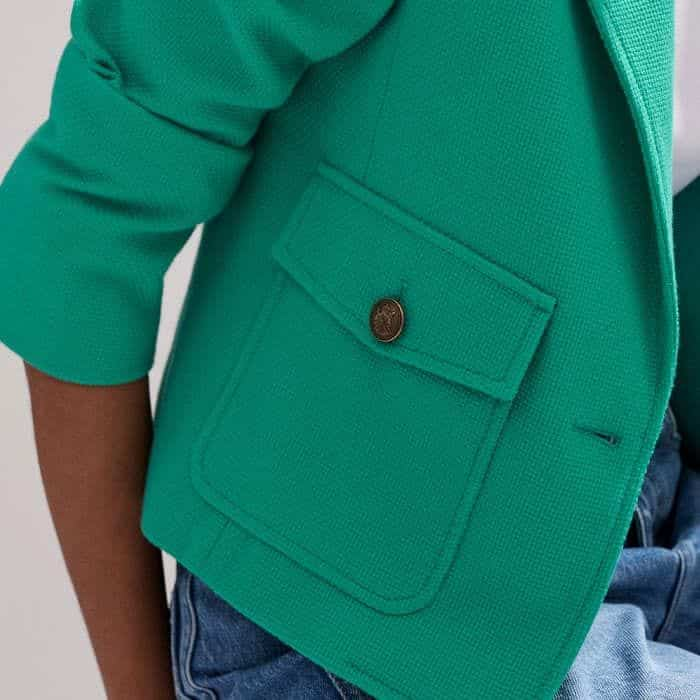 The patch pockets are elevated with an embossed button detail.