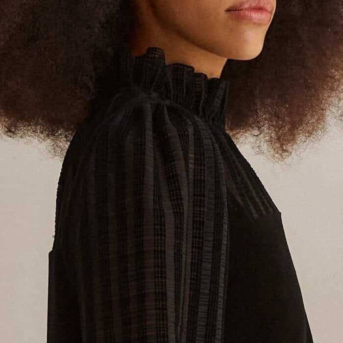 A slight pouf at the shoulder introduces flattering volume to the tops of the long sleeves.