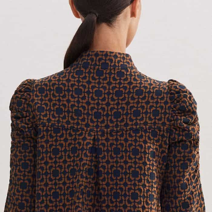 Ruching at the shoulders adds flattering volume to the sleeves.