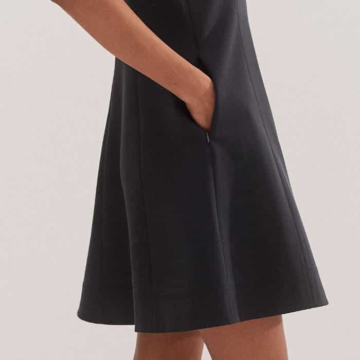 The fitted bodice falls to a flared, short-length skirt for an effortless finish.