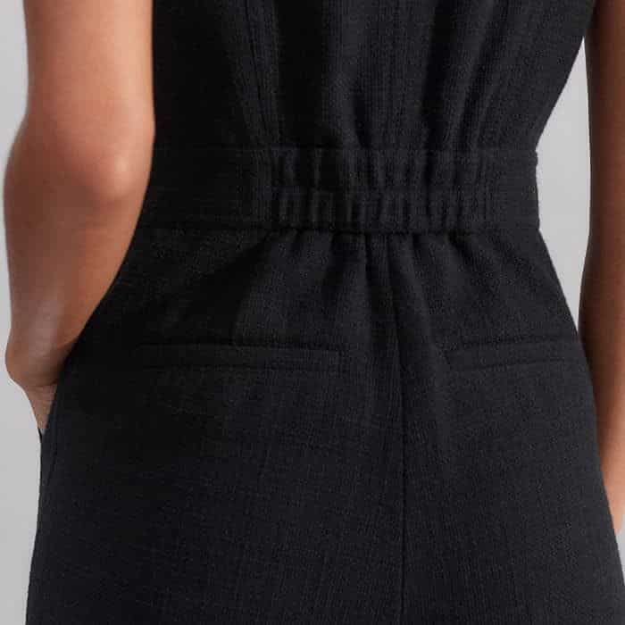 To create a subtly more defined waist, the back is detailed with an elasticated panel.