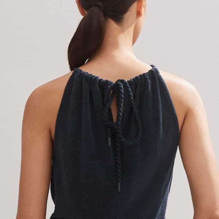 Perfect the fit with the adjustable halterneck that ties at the back of the piece.