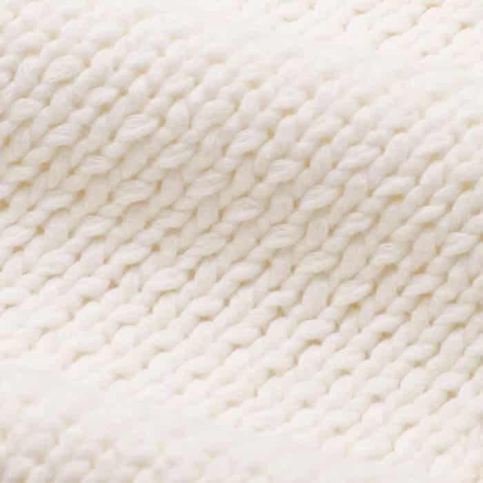 Pure cotton knitted in a chunky 3gg plain stitch with ribbed trims. Clean appearance with a dry but soft hand feel.