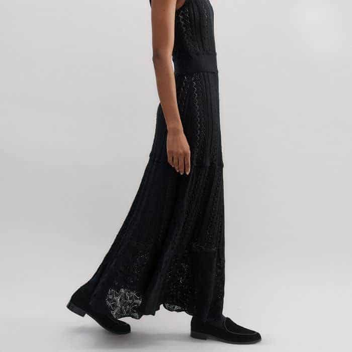 The fitted bodice falls to a flowing, flared maxi skirt.