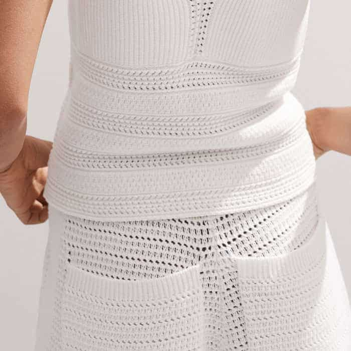 To line up seamlessly with the high waistline of shorts and skirts, the length is cropped.