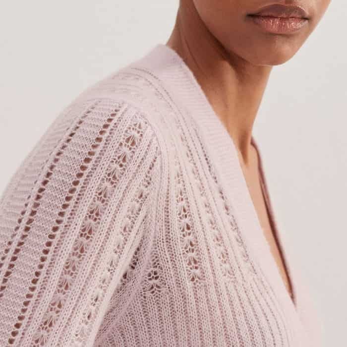 The delicate lace stitch adds interest to the sleeves, hem and shoulders.