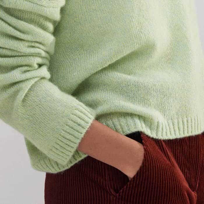 A ribbed trim at the hem and cuffs adds structure to the piece.