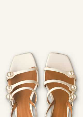 Providing extra support, three straps decorated with faux pearls make their way along the foot. 