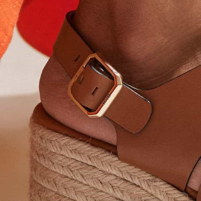 The adjustable matte gold-plated buckle features bespoke ME+EM branding.