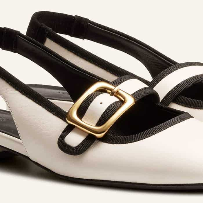 A gold-toned buckle adds metallic interest to the monochrome palette.