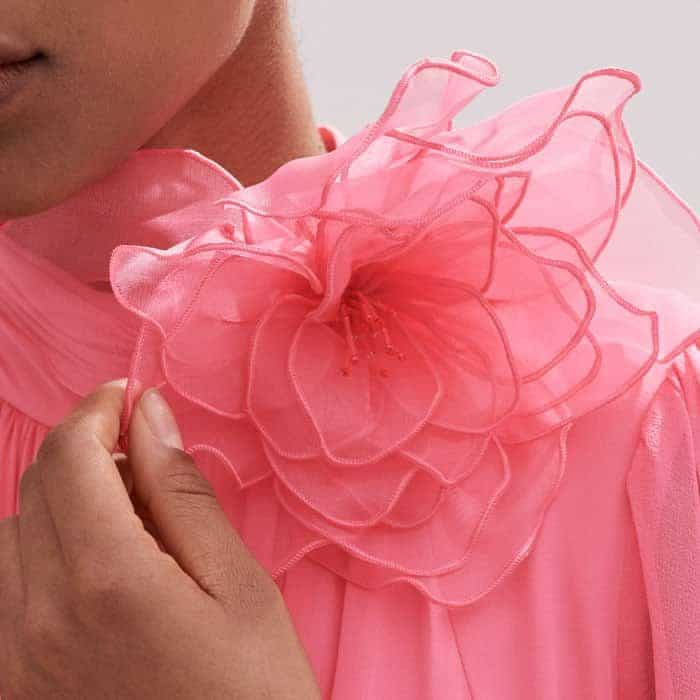 Add a floral detail to the neckline of the piece with the complimentary corsage.