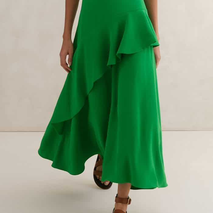 A statement ruffled trim makes its way across the skirt for a feminine finish. 