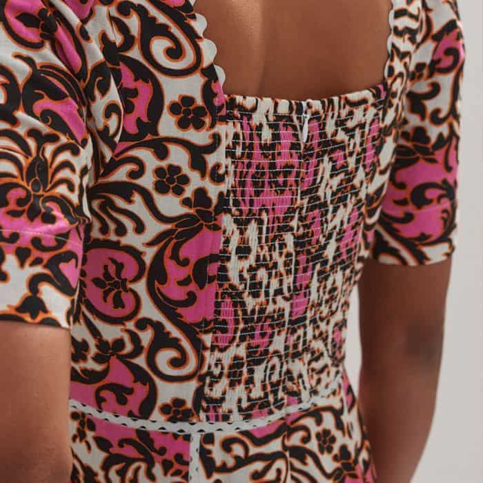 The back of the dress features a shirred panel for additional comfort.