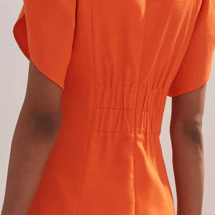 An elasticated panel at the back of the dress adjusts to fit your body for a flattering finish.