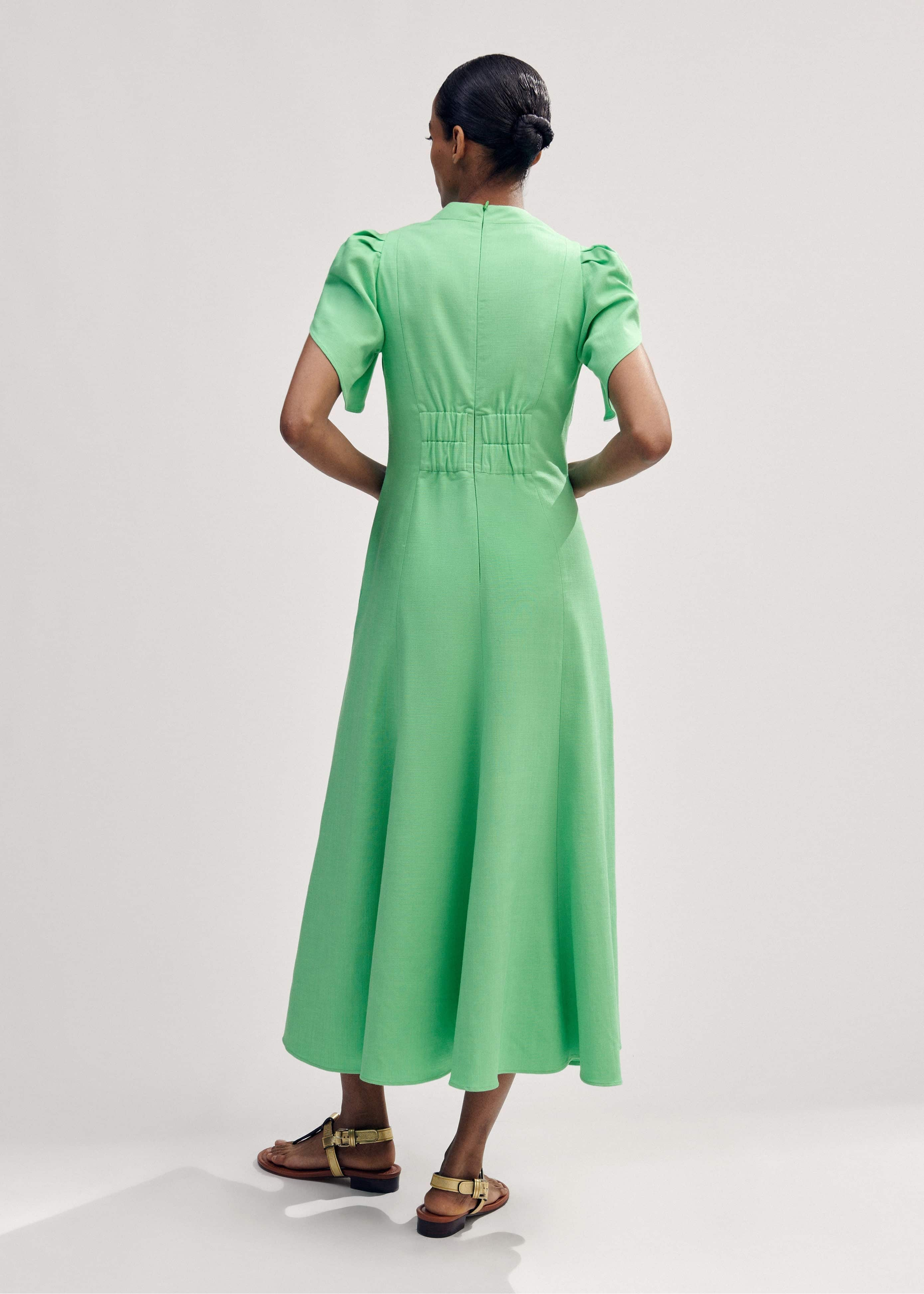 Crafted from a textured viscose blend fabric with flattering ruching down the centre of the piece.