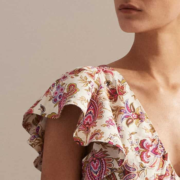 Adding a playful finish to the silhouette, the shoulders are elevated with a ruffled detail. 