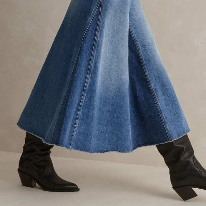 Contrasting darker denim godet pleats add definition to the silhouette.