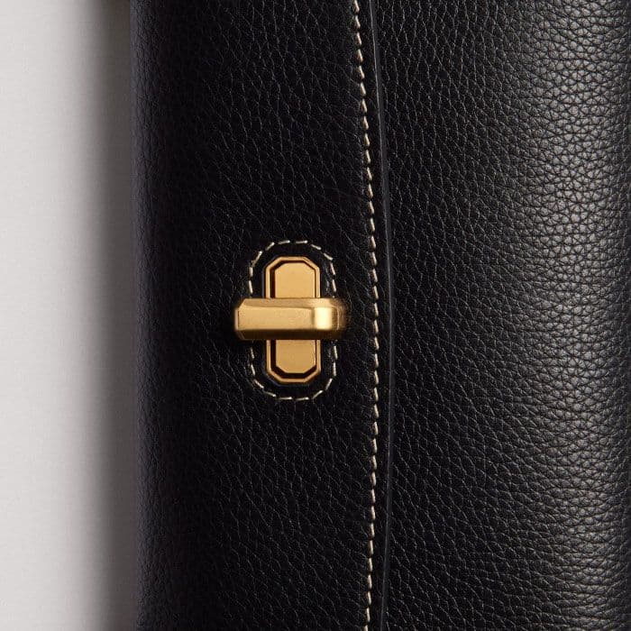 The gold-plated twist-and-lock fastening is elevated with bespoke block branding.