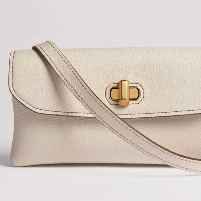 The length of the leather strap can be adjusted to switch between a shoulder and a crossbody style.