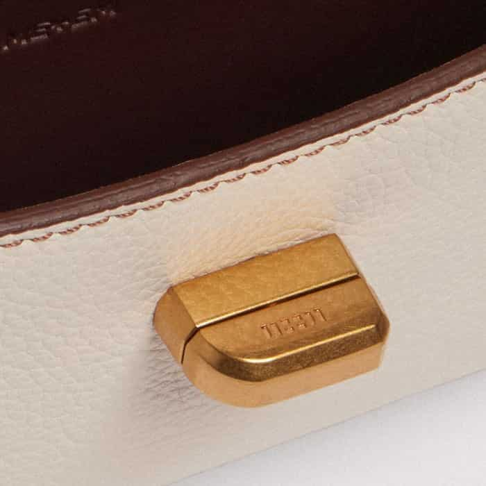 Bespoke block branding elevates the gold-plated twist-and-lock fastening.