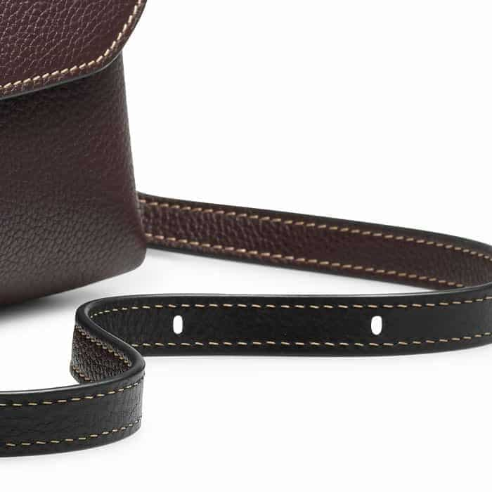 Switch between a crossbody and a shoulder bag with the adjustable strap.