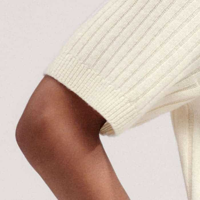 Ribbed trims at the hem, neckline and cuffs maintain the fit of the piece.