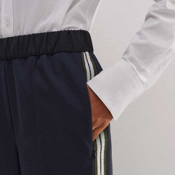 Flatteringly placed pockets add functionality.